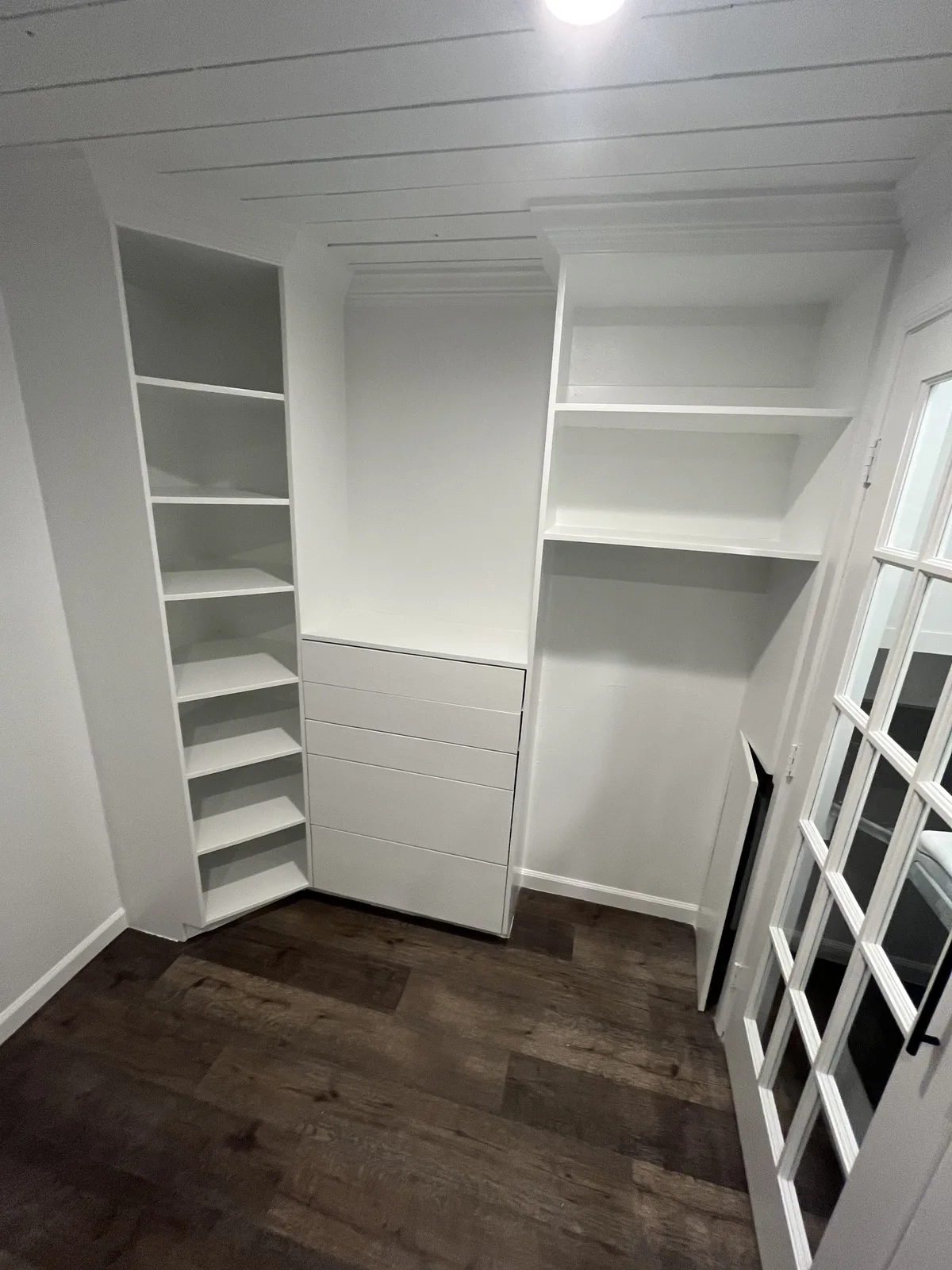 Finished closet showing the opposite wall and shelving