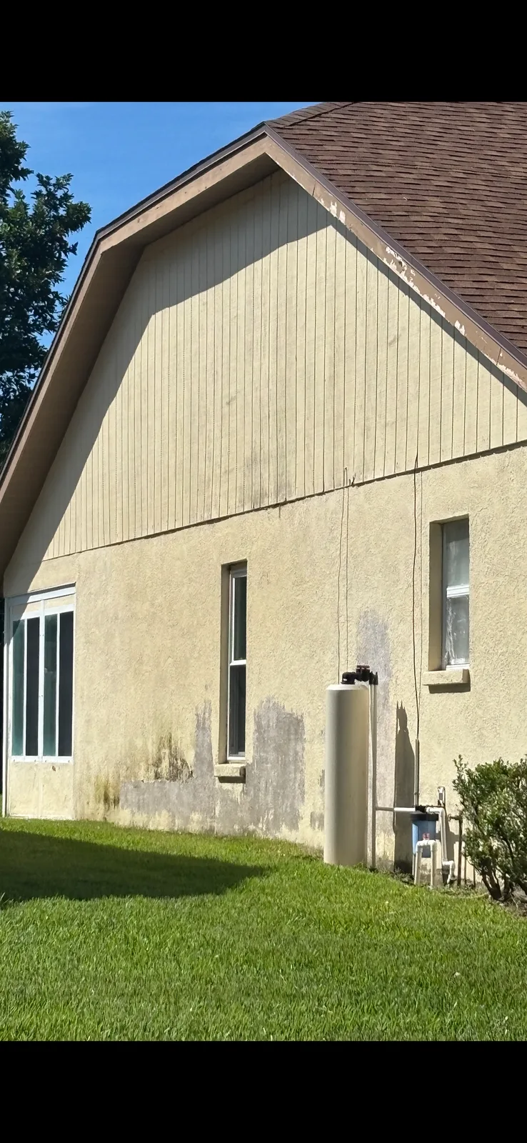 Before detail of the same stucco house shown in the after photo